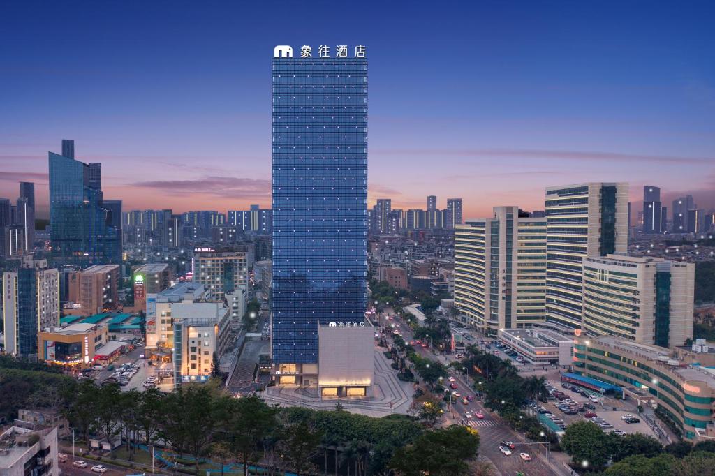 a tall building in the middle of a city at Elephant Hotel in Zhuhai