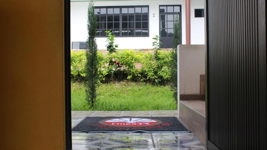 an open door with a rug in front of a house at El Rincón Preferido in Papantla de Olarte