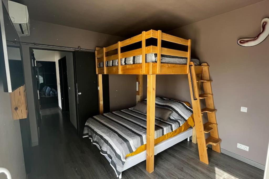 two bunk beds in a room with a ladder at maison 3 chambres avec piscine in Calvi