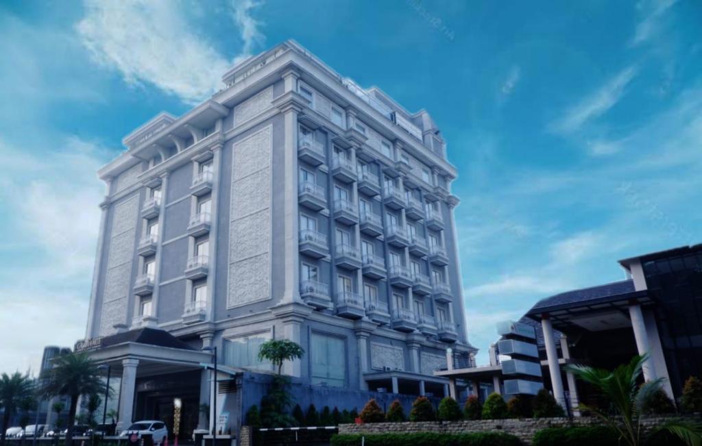 een groot wit gebouw in een stadsstraat bij The Grantage Hotel & Sky Lounge in Serpong