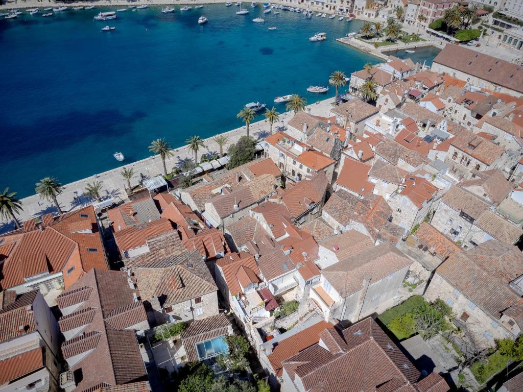 an aerial view of a town with houses and the water at The Renaissance - Hvar in Hvar