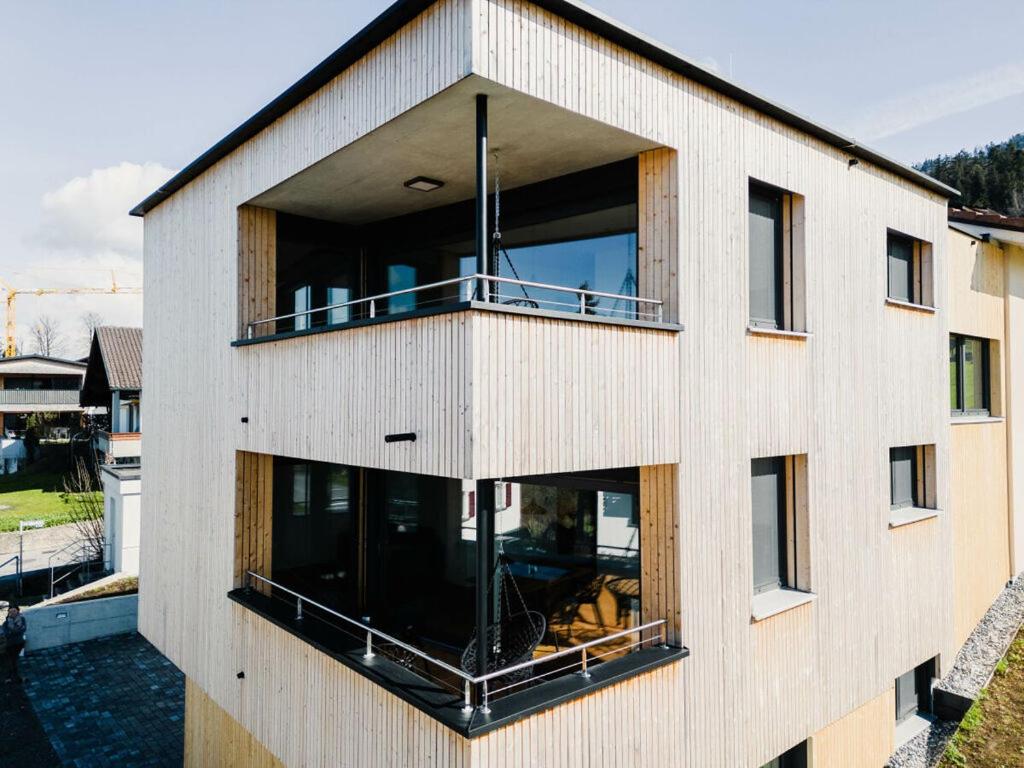 a building with large windows on the side of it at Holiday apartment 3 in the holiday home Sandra in Hörbranz