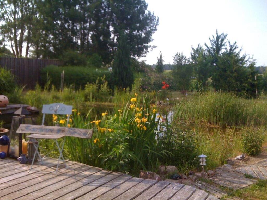 a garden with a bench on a wooden deck at Krusch Modern retreat 