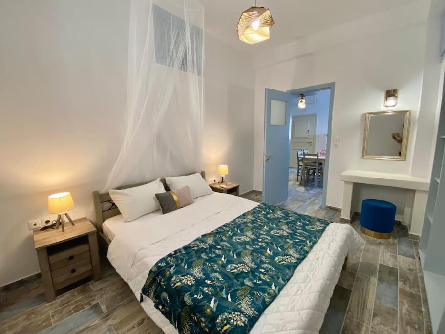 a bedroom with a bed and a table and a fireplace at Evdokia's House Amorgos-Chora in Amorgos