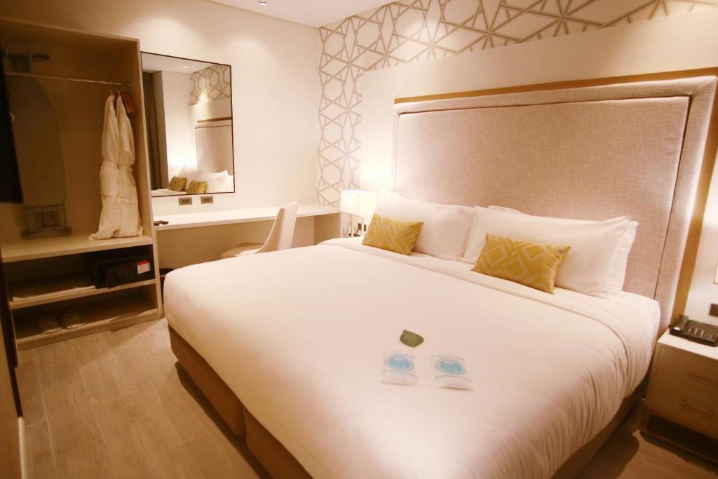 Postel nebo postele na pokoji v ubytování Summit Hotel Naga