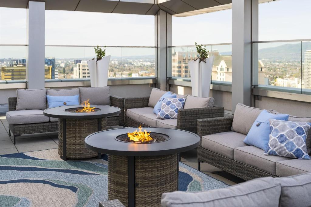 a rooftop patio with couches and fire pits at San Jose Marriott in San Jose