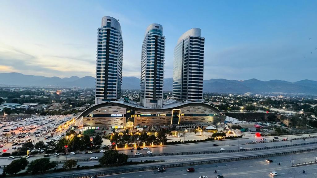 a city with three tall buildings and a highway at Centaurus Mall & Residency Luxury Apartments in Islamabad