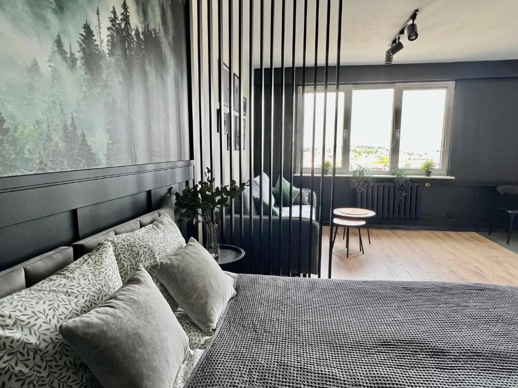una camera da letto con un letto e una sedia in una stanza di Apartament Przytulny 5 - Las, self check in, dworzec PKP a Rzeszów