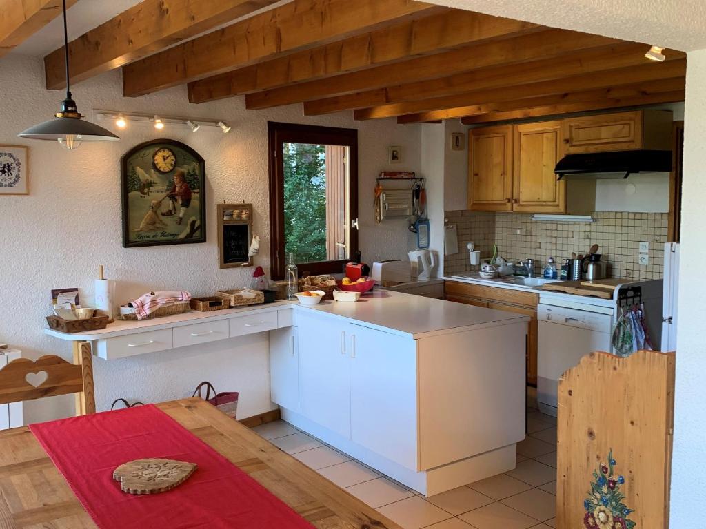 a kitchen with white cabinets and a counter top at Appartement Villard-de-Lans, 4 pièces, 8 personnes - FR-1-761-6 in Villard-de-Lans