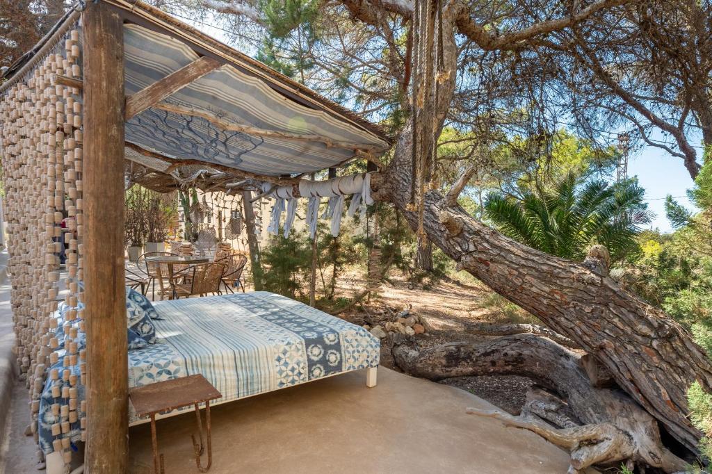 a bed in a tree with a canopy at El Dorado in Es Pujols