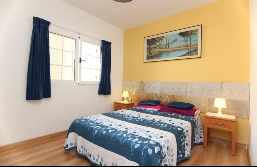 a bedroom with a bed and a window at Gran Canaria Las Palmas Apartment in Mogán