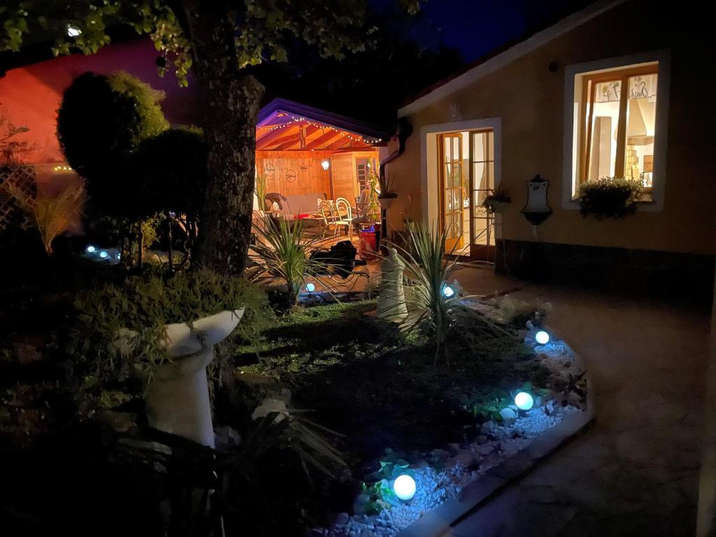 a house with lights in the yard at night at Villa Noa jacuzzi & sauna in Izola