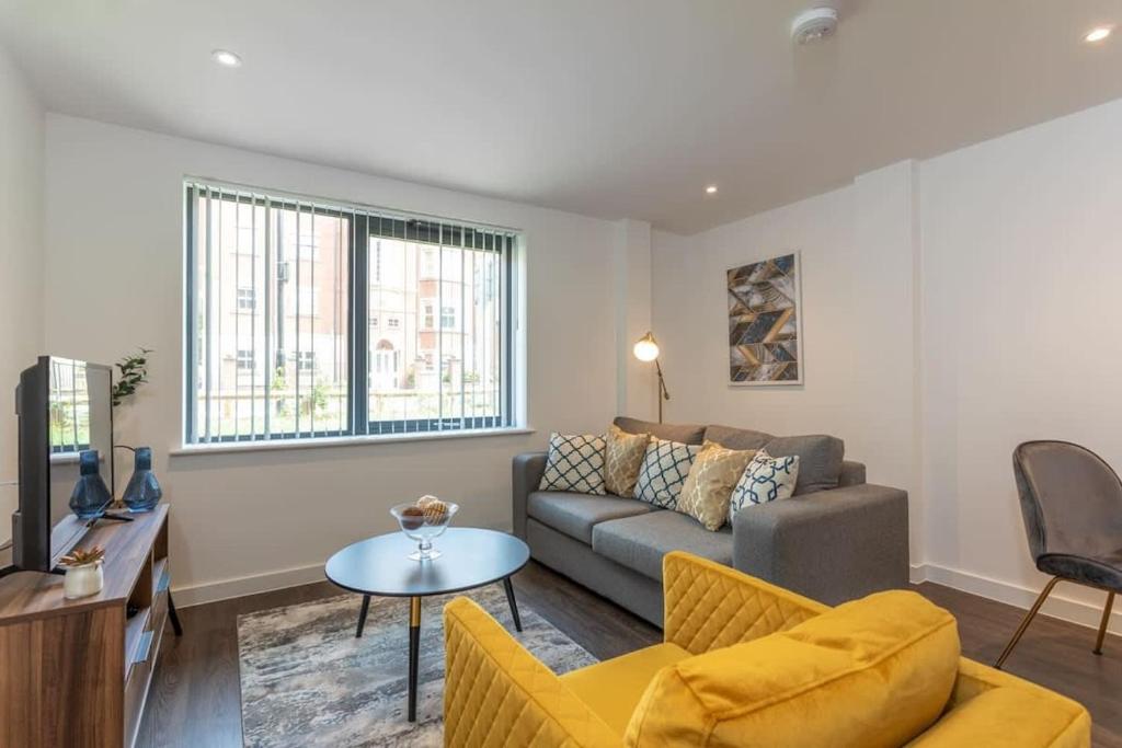 a living room with a couch and a table at Luxurious 1 bed apartment with free parking in York