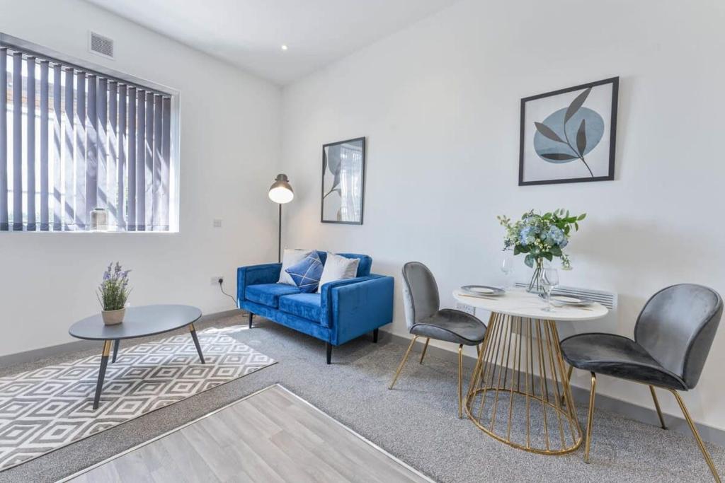 a living room with a blue couch and chairs at Contemporary & Cosy 1 Bed Apartment in Dudley in Brierley Hill