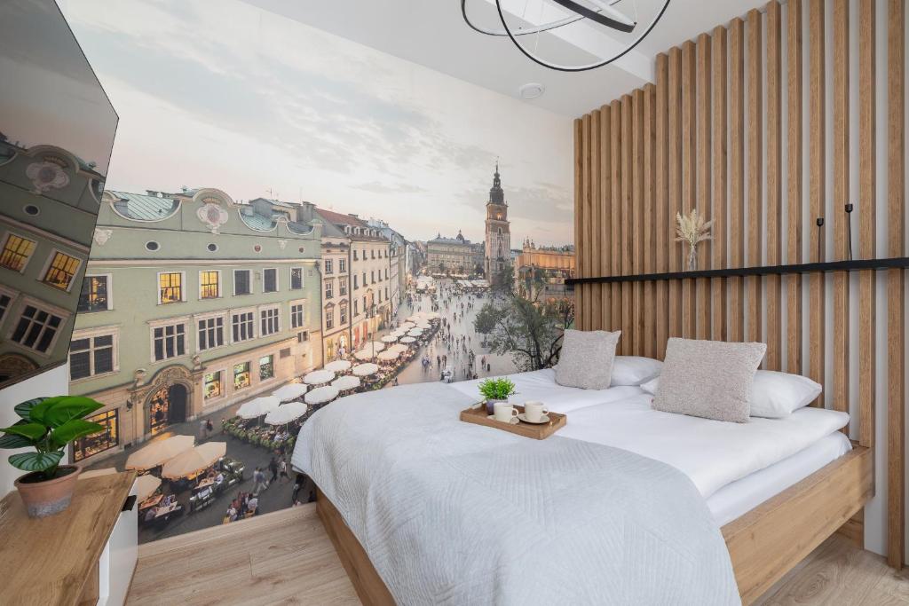 a bedroom with a large bed with a view of a city at Rakowicka Modern Studio in Downtown Cracow by Rent like home in Kraków