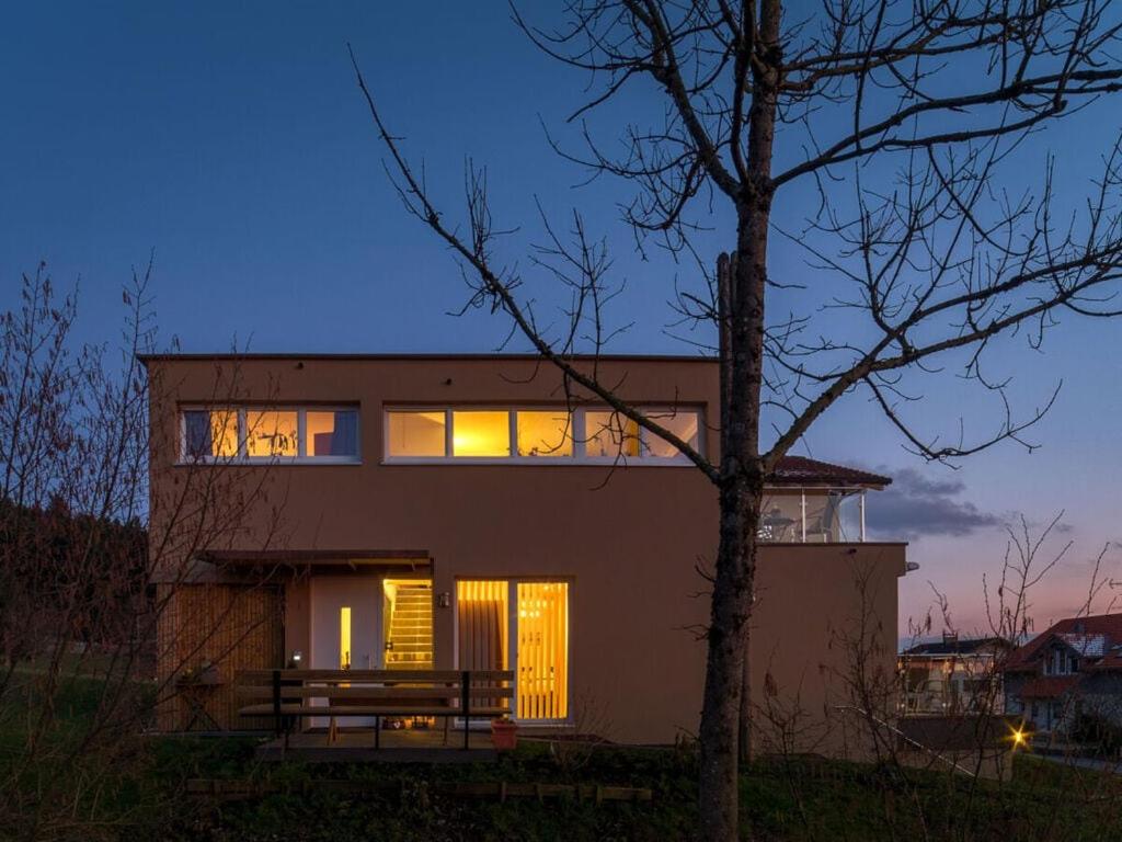 a house with its windows lit up at night at 2 in holiday home Sandra in Hörbranz