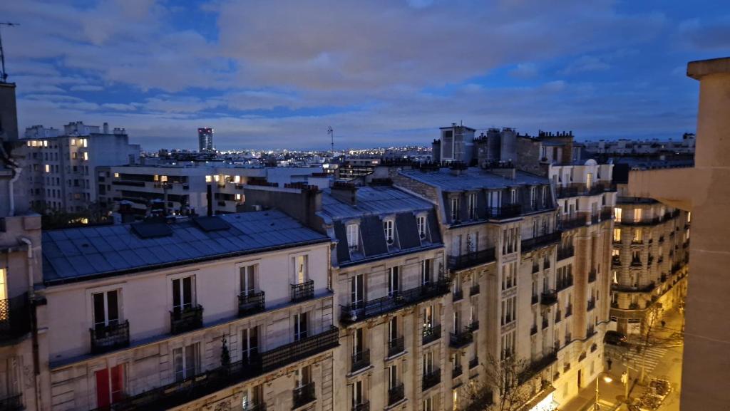 a group of buildings in a city at night at Michel Ange in Paris