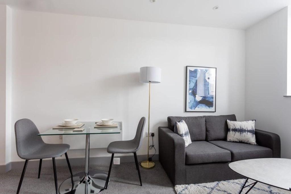 a living room with a couch and a table at Contemporary 1 Bedroom Apartment Leeds in Leeds