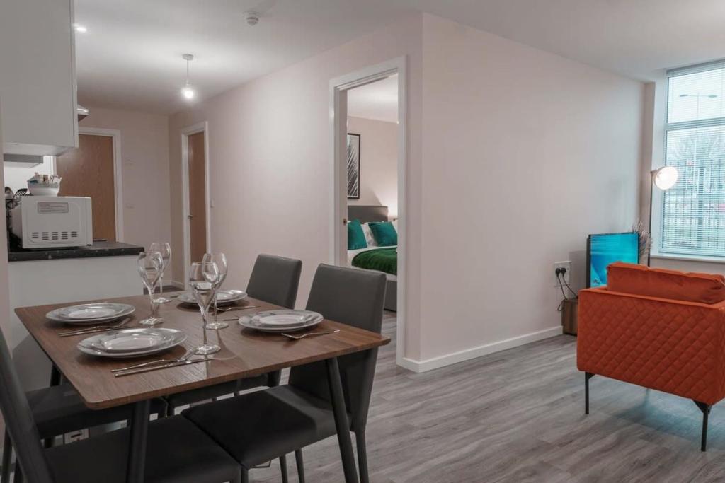 uma sala de jantar com uma mesa e cadeiras num quarto em Modern 2 Bed Apartment in Manchester - Sleeps 4 em Manchester