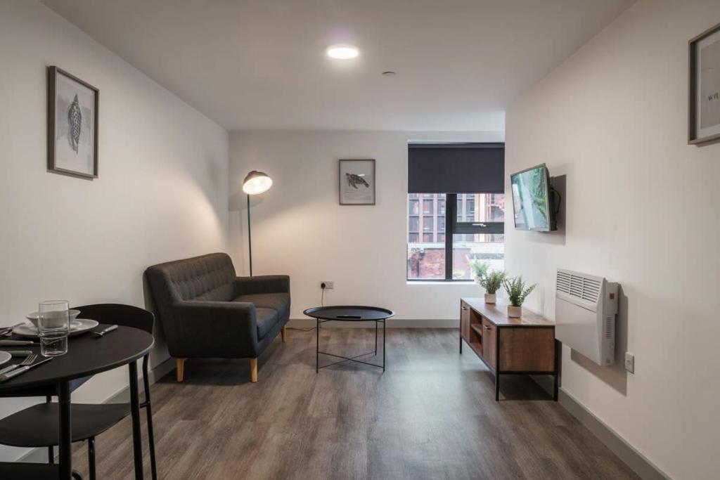 a living room with a chair and a table at Modern 1 Bed Apartment in Liverpool Centre in Liverpool