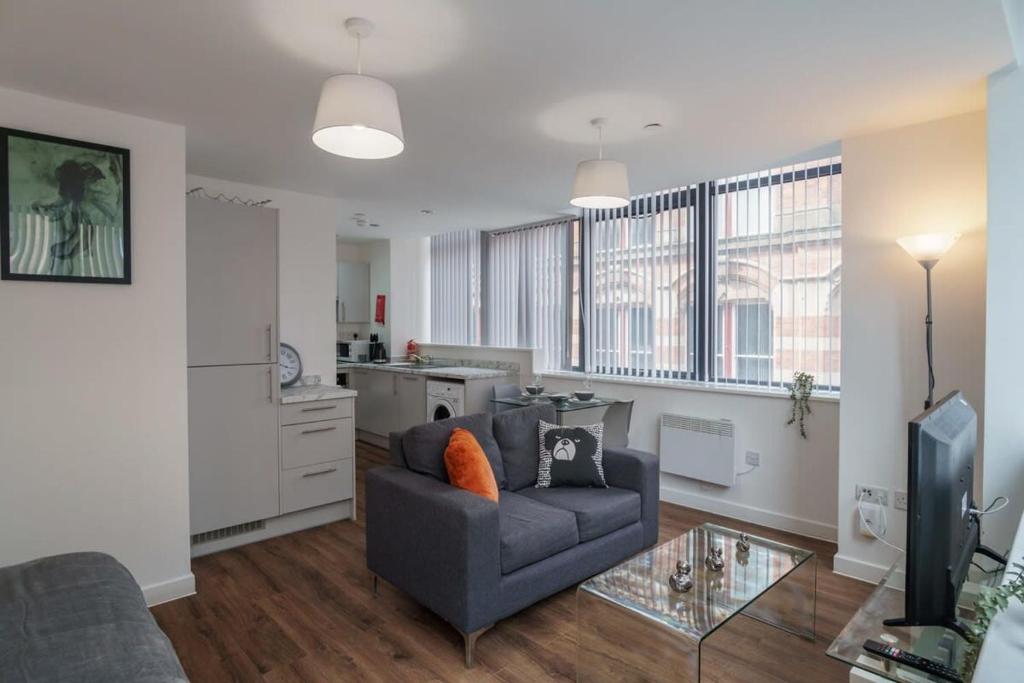 a living room with a couch and a tv in it at Modern Studio Apartment in Central Liverpool in Liverpool