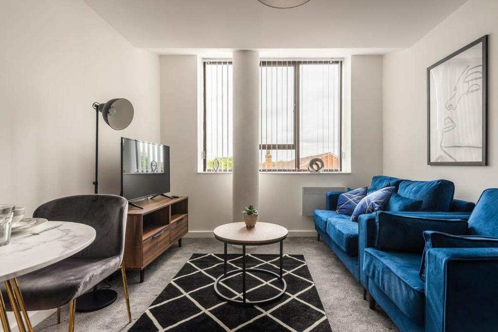 sala de estar con sofá azul y mesa en Modern 1 Bed Apartment in Central Retford, en Retford