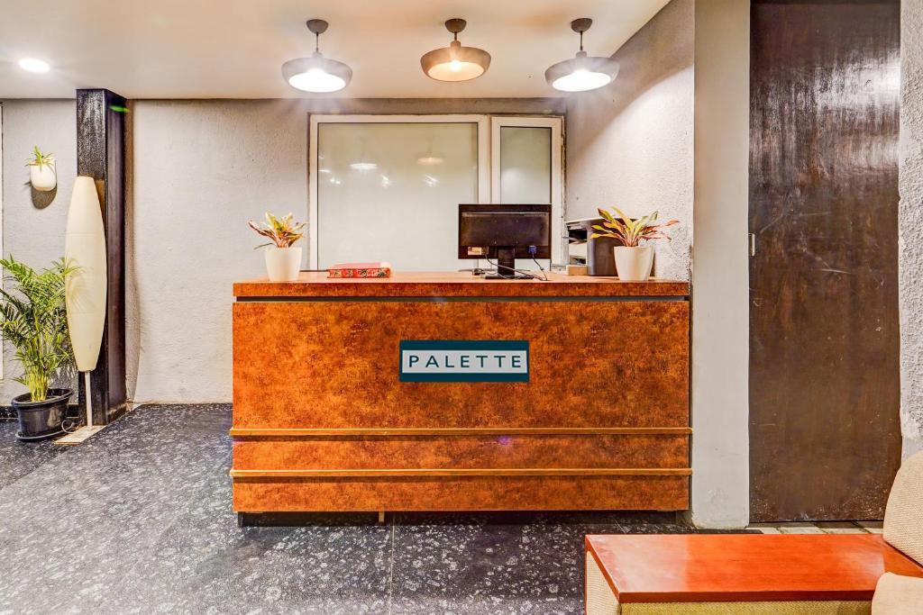 an office reception desk with a patric sign on it at Palette - The Slate Hotel in Chennai