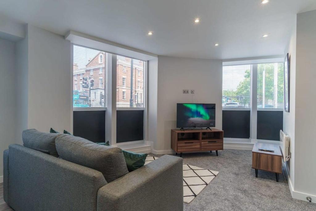 a living room with a couch and a flat screen tv at Fantastic 1 Bedroom Apartment in Liverpool in Liverpool