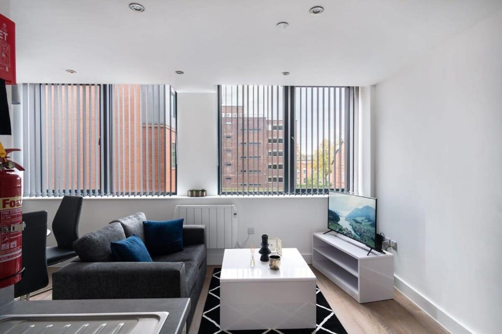 a living room with a couch and a table at Fantastic Studio Apartment by Old Trafford in Manchester