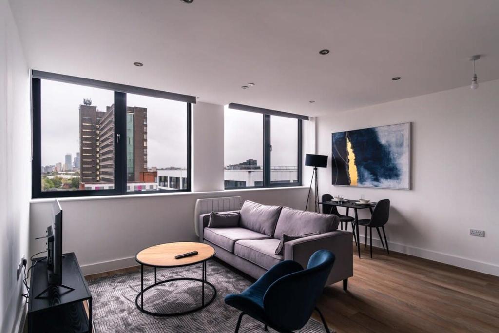 a living room with a couch and a table at Charming 1 Bed Apartment in Old Trafford in Manchester