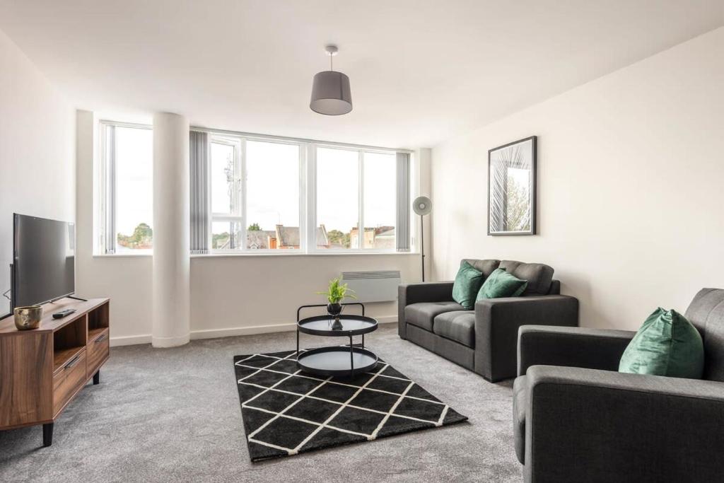 a living room with a couch and a tv at Contemporary 1 Bed Apartment in Central Retford in Retford