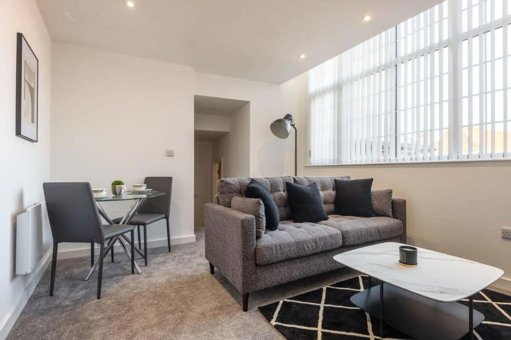 a living room with a couch and a table at Modern 2 Bedroom Apartment in Central Hull in Hull