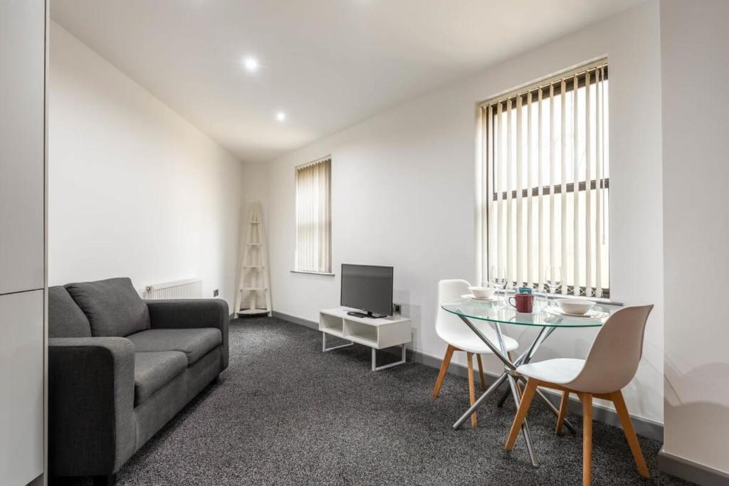 a living room with a couch and a table at Lovely 1 Bed Budget Apartment in Central Halifax in Halifax