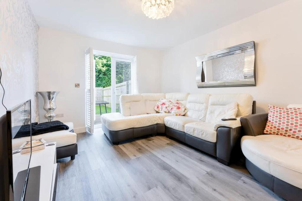 a living room with a couch and a table at Modern 2 Bedroom House in Wolverhampton in Wolverhampton