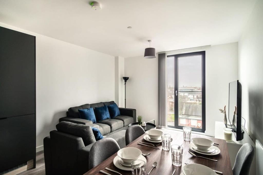 a living room with a couch and a table at Stunning 2 Bedroom Apartment in Central Preston in Preston