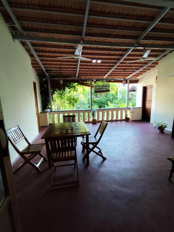 a room with a table and chairs in a building at Brindaven in Mysore