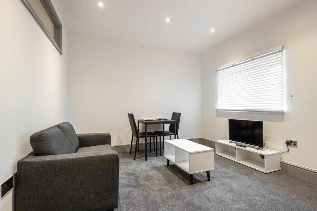 a living room with a couch and a table at Contemporary 1 Bed Budget Apartment in Darlington in Darlington