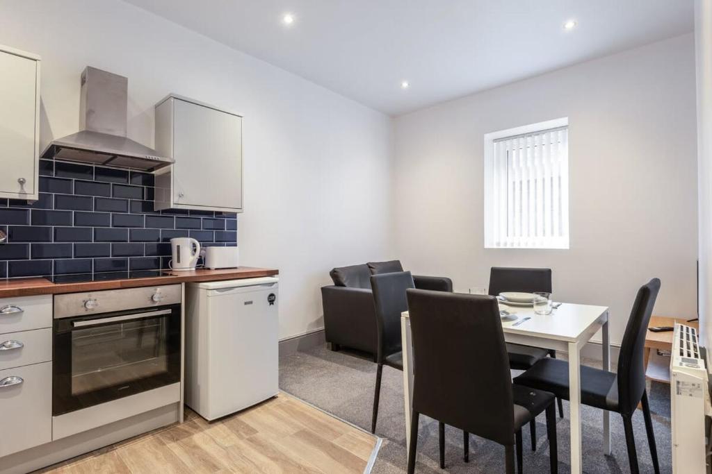 a kitchen and dining room with a table and chairs at Modern 1 Bed Budget Apartment in Darlington in Darlington