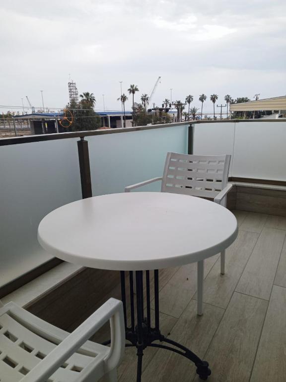 a white table and two chairs on a balcony at Port Hotel, Tasucu in Silifke