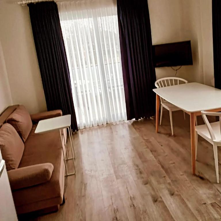a living room with a couch and a table at Port Hotel, Tasucu in Silifke