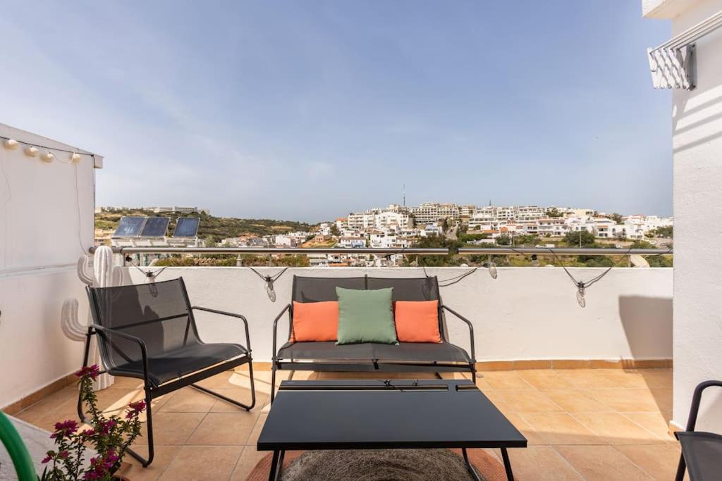 a balcony with two chairs and a table and a view at Casinha da Jade in Albufeira