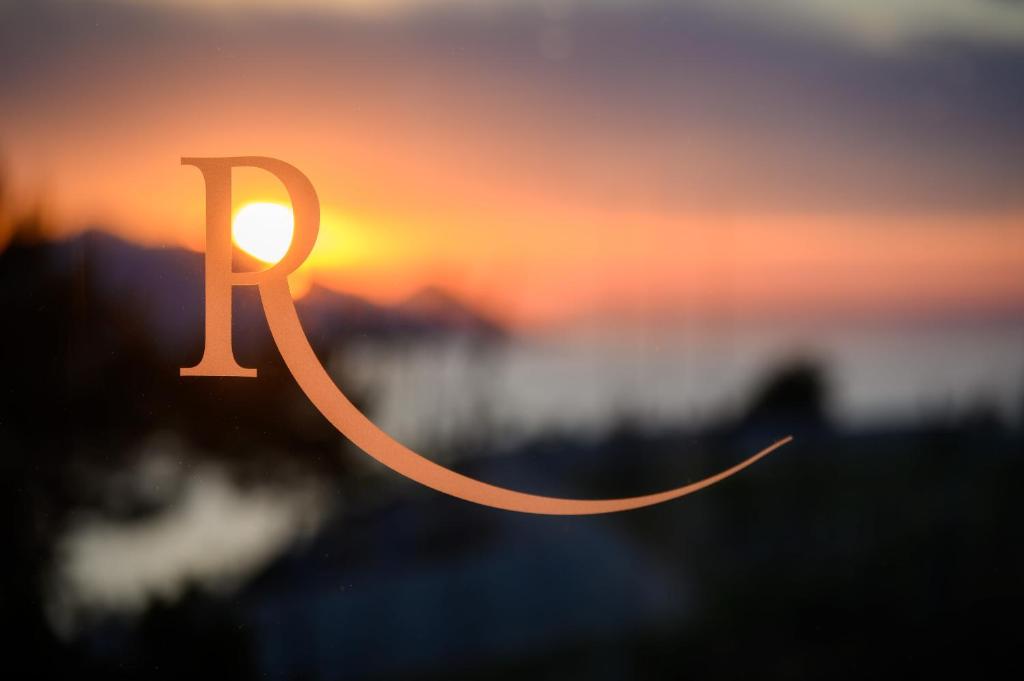 a wooden cutout of the word ja in front of a sunset at Winery Rizman B&B in Slivno Ravno