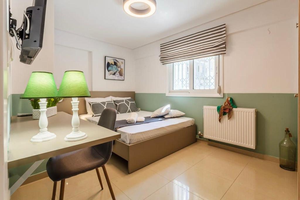a bedroom with a bed and a desk with a desk at Kalamata Lime Studio - Cozy Gem with Private Parking in Kalamata