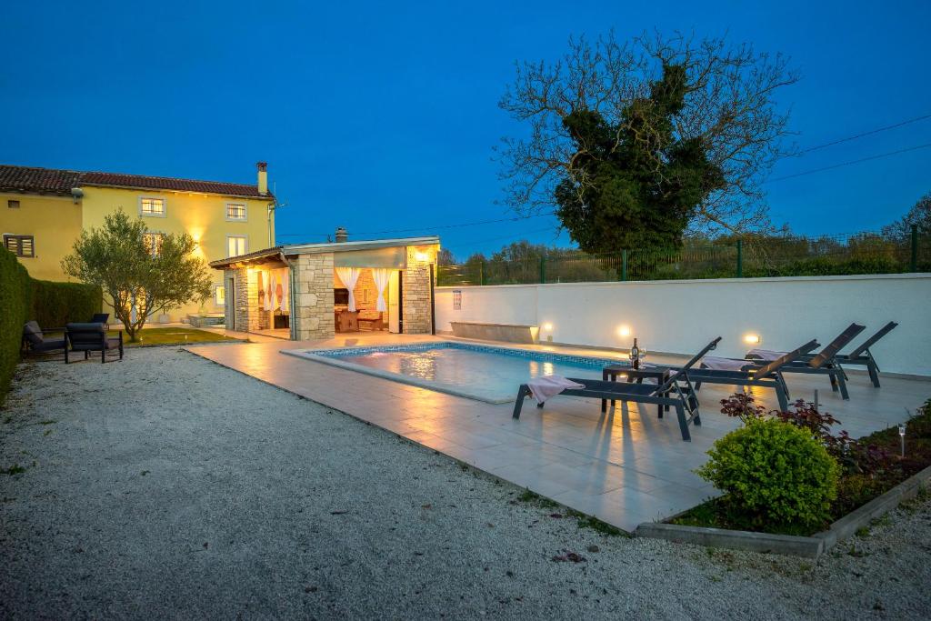 een achtertuin met een zwembad in de nacht bij Villa Bilinke by IstriaLux in Štokovci