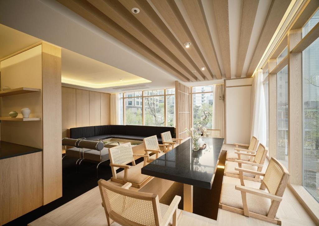 a dining room with a table and chairs at UH Suite Seoul Deoksugung in Seoul