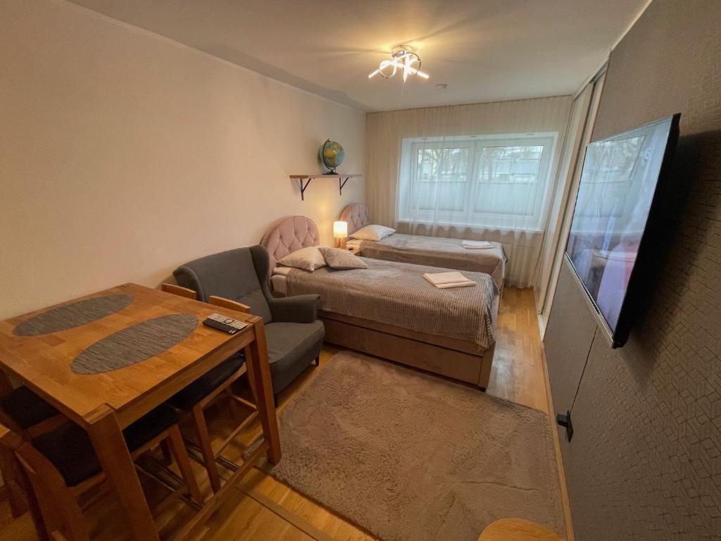 a small room with a bed and a table at Rohuaia 22 Apartment in Rakvere