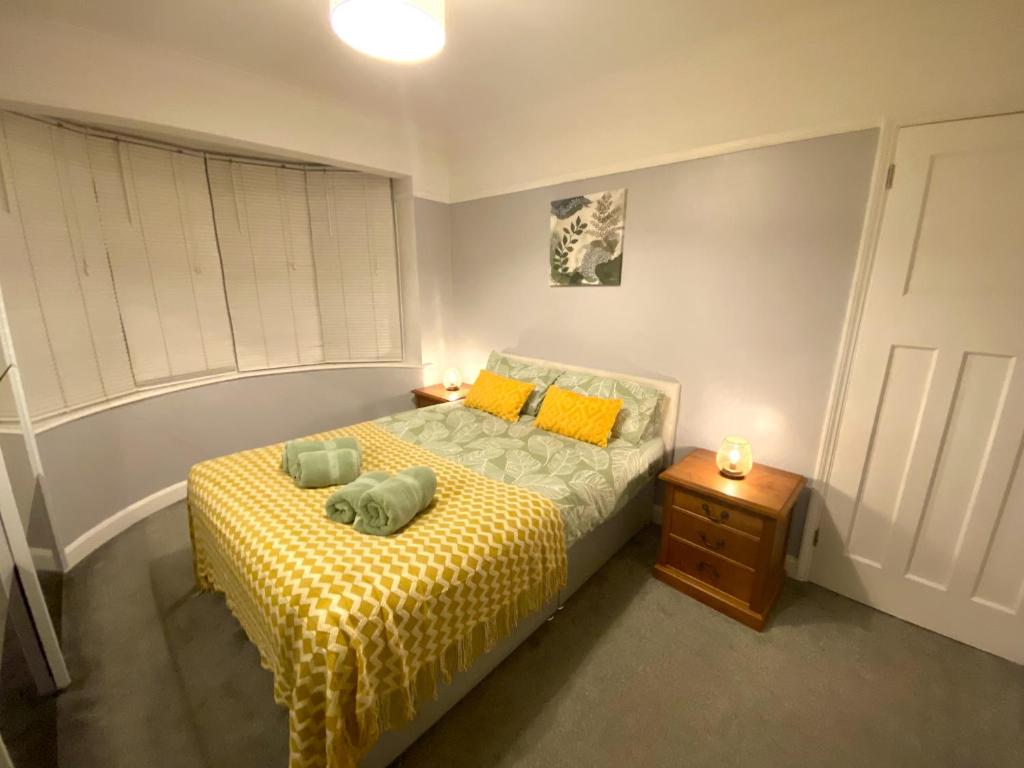 a bedroom with a bed with two pillows on it at 4 Bedroom House near City Centre with Parking in Gloucester