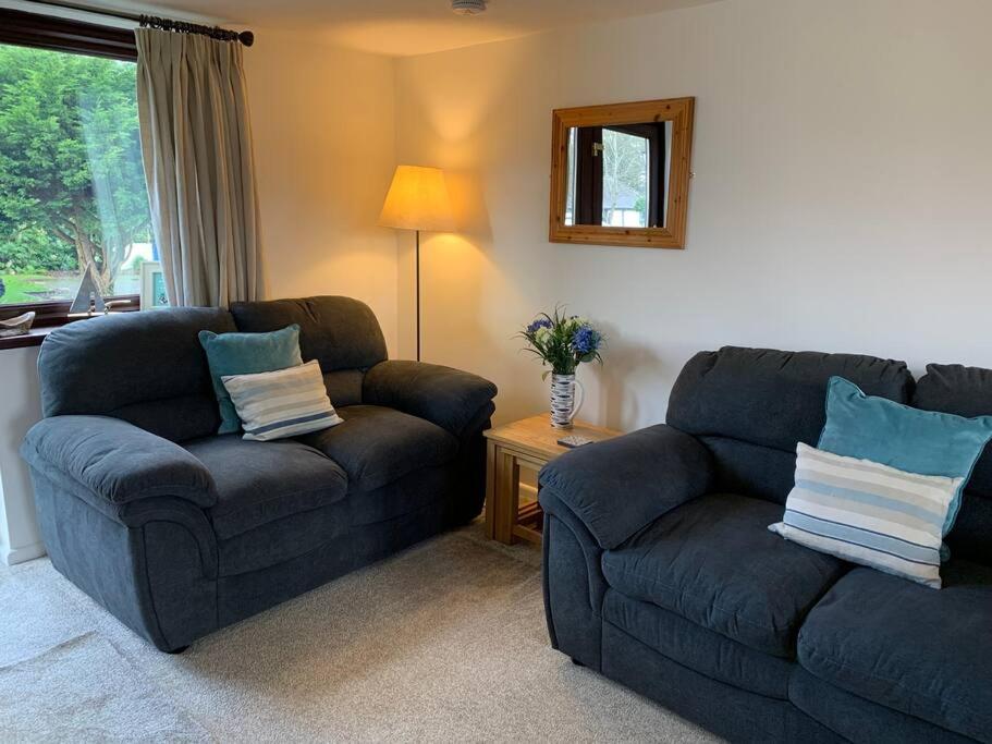 a living room with a couch and a chair at Cosy cottage between Penzance and St Ives in Gulval