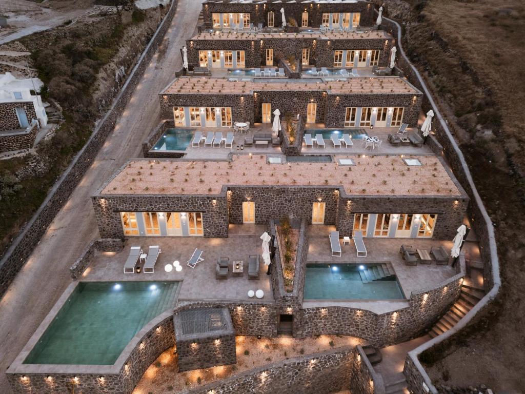 an aerial view of a mansion with several pools at Almarossa Luxury Villas in Vourvoulos