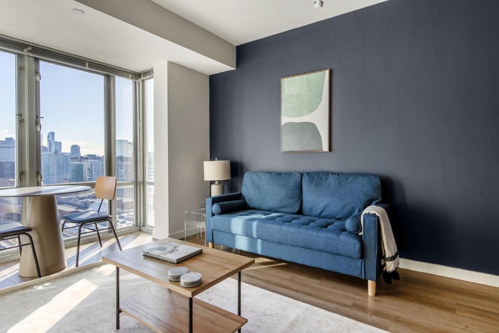 a living room with a blue couch and a table at East Cambridge 1br w gym wd near T stop BOS-958 in Boston